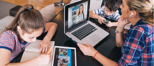 Mother trying to talk with doctor on laptop while watching two kids staying home  Homeschooling and distance learning