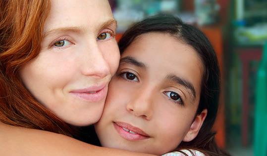 multiracial american mother and daughter family hug