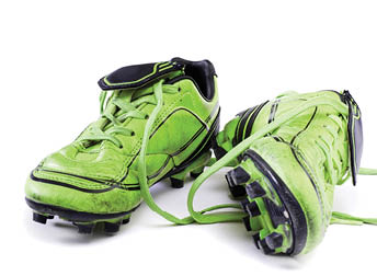 Green soccer cleats isolated on white background 