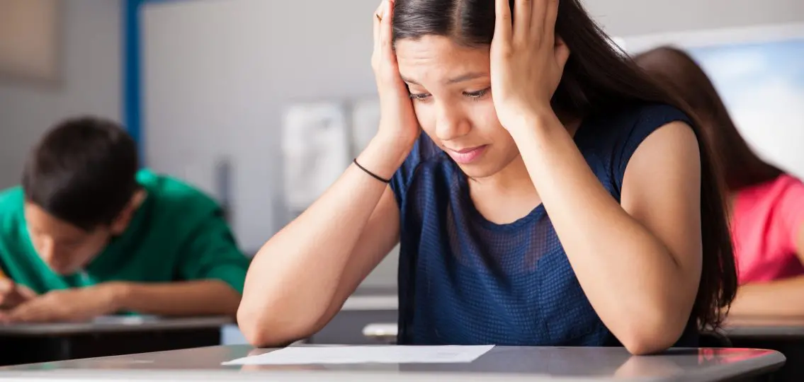 teenage girl stressed out during a test for high school