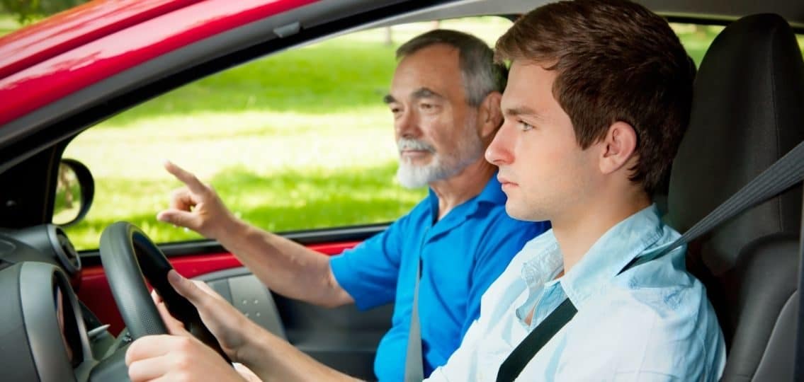teenager learning to drive in car with parent or instructor