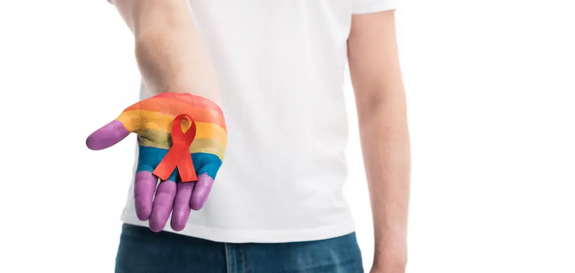 Gay Flag Painted Hand outstretched with a ribbon white background