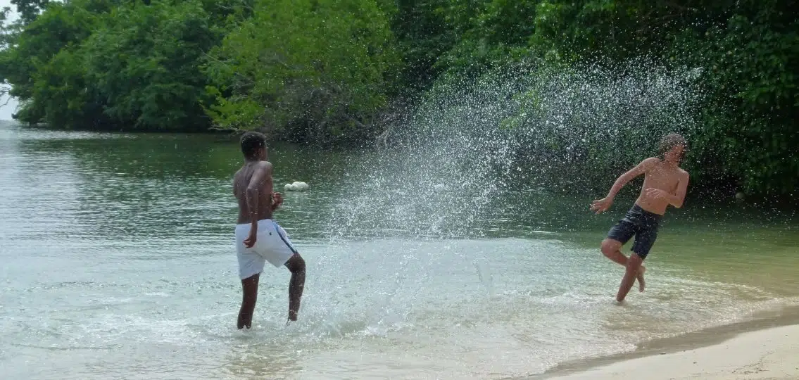 middle school boys splashing in the water