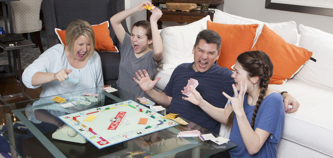 Family playing monopoly together and getting angry