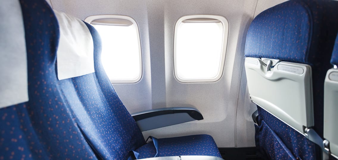 blue seats in economy class passenger section of airplane