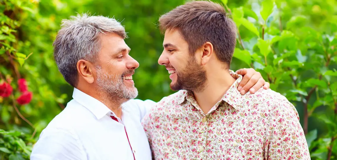 portrait of happy father and son that are similar in appearance outside