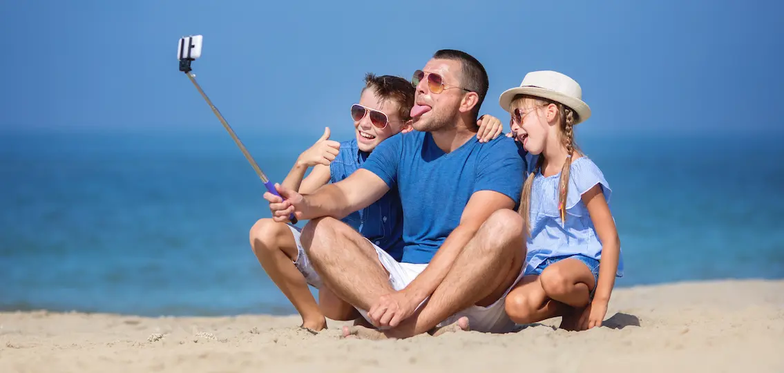 Father with children taking selfie. Summer, family, vacation concept