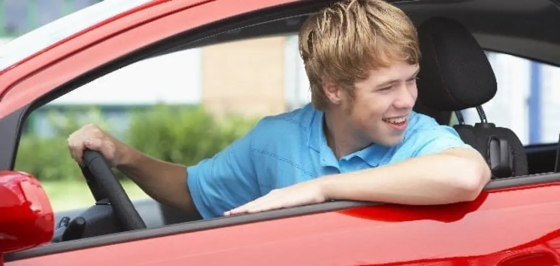 Teen driver back up car looking backwards out window