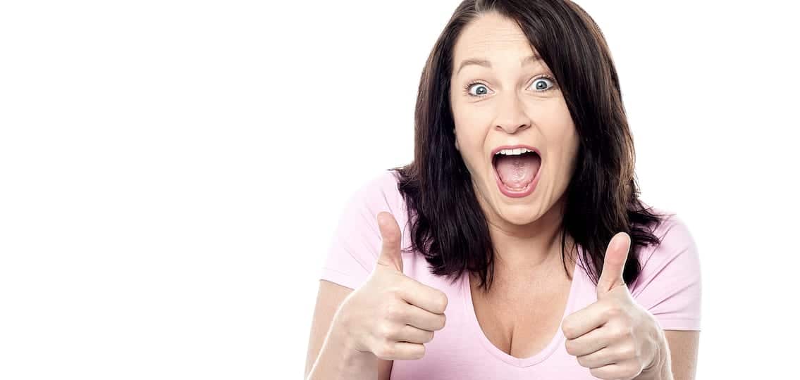 Excited woman showing double thumbs up