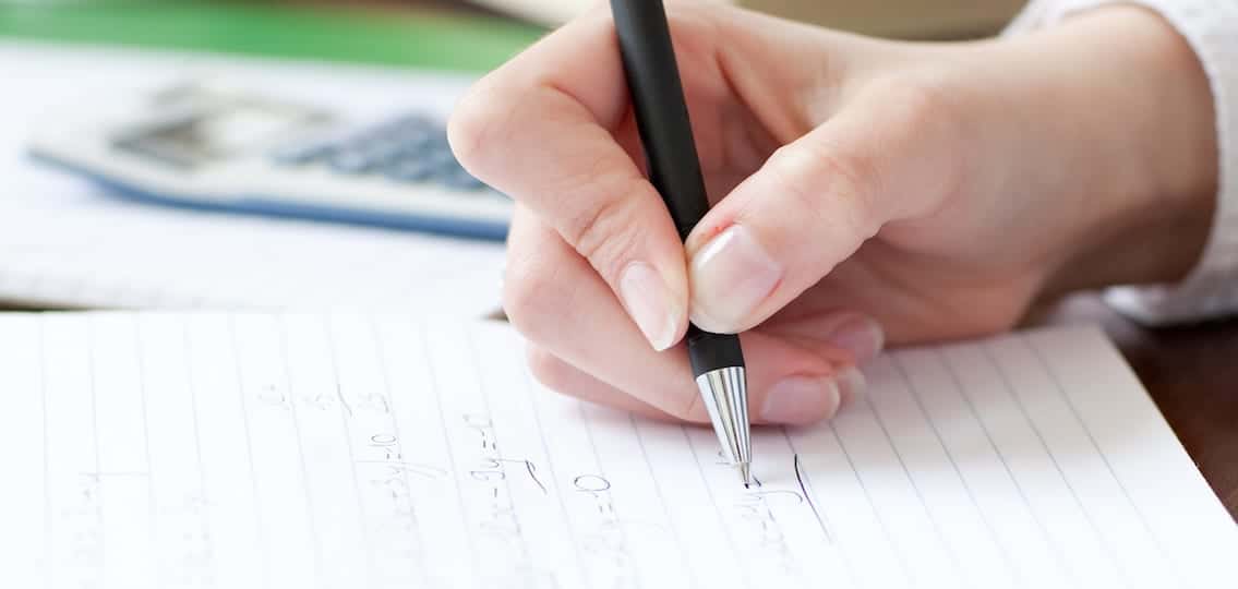 Close-up of a student doing her homework at home