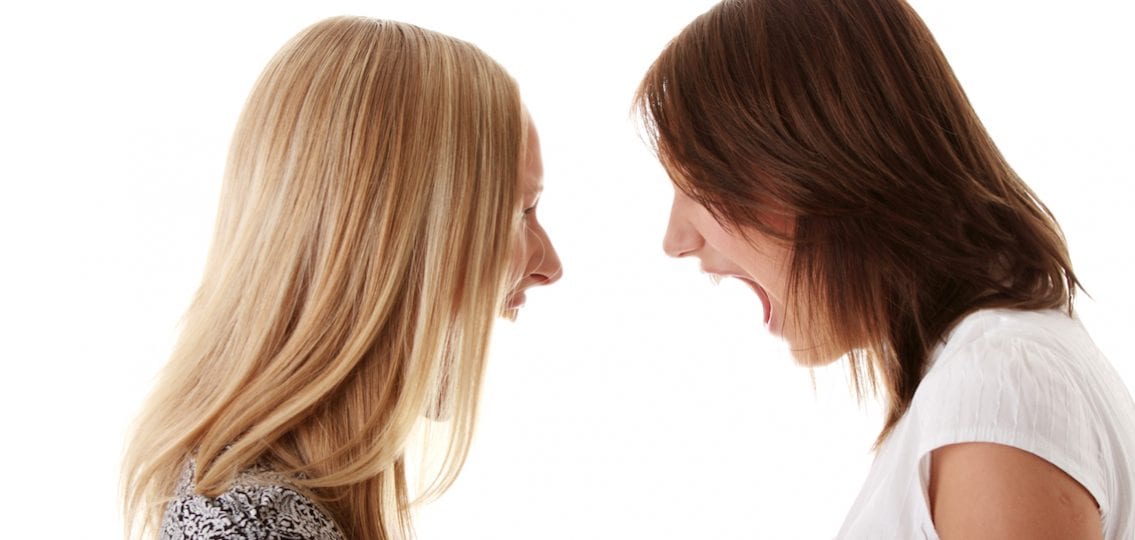 Two Angry teen girls Shouting Each Other white background