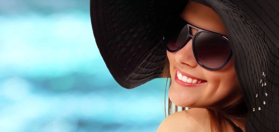 teen girl wearing sun hat and sunglasses for sun protection