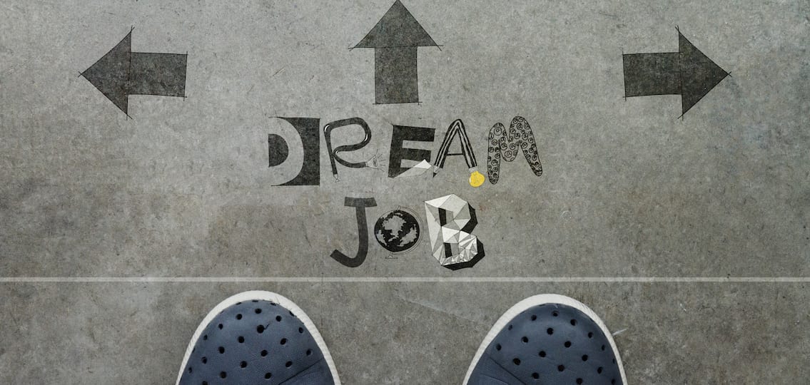 Hand drawn DREAM JOB design word on front of business man feet as concept
