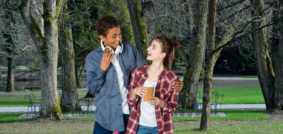 a 14-year-old with boyfriend in the park smiling