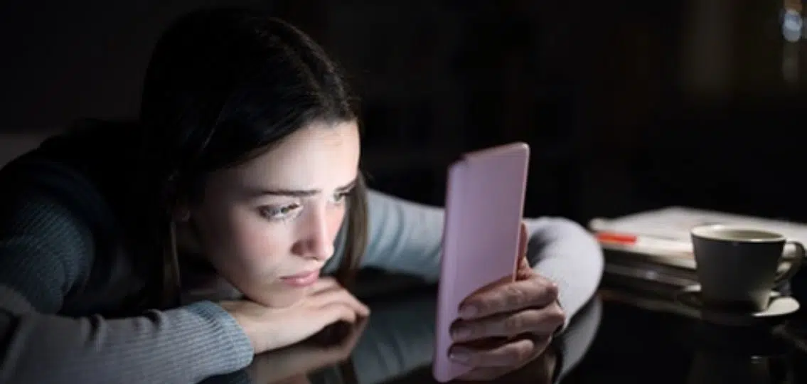 Teen on her phone struggling with FOMO