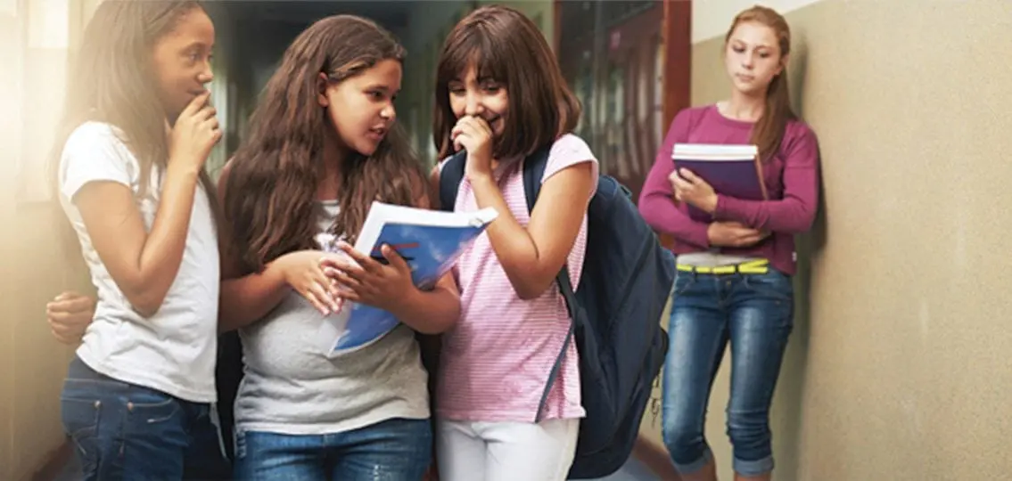 Popular teen girls bullying lonely girl at school