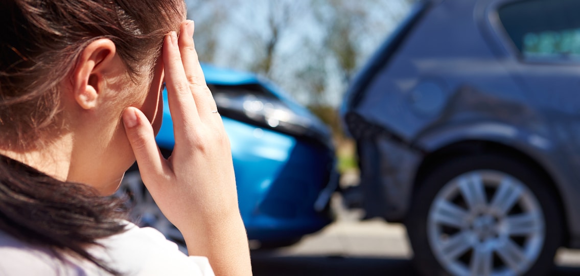 Car crash crying teenager looking at her wrecked car
