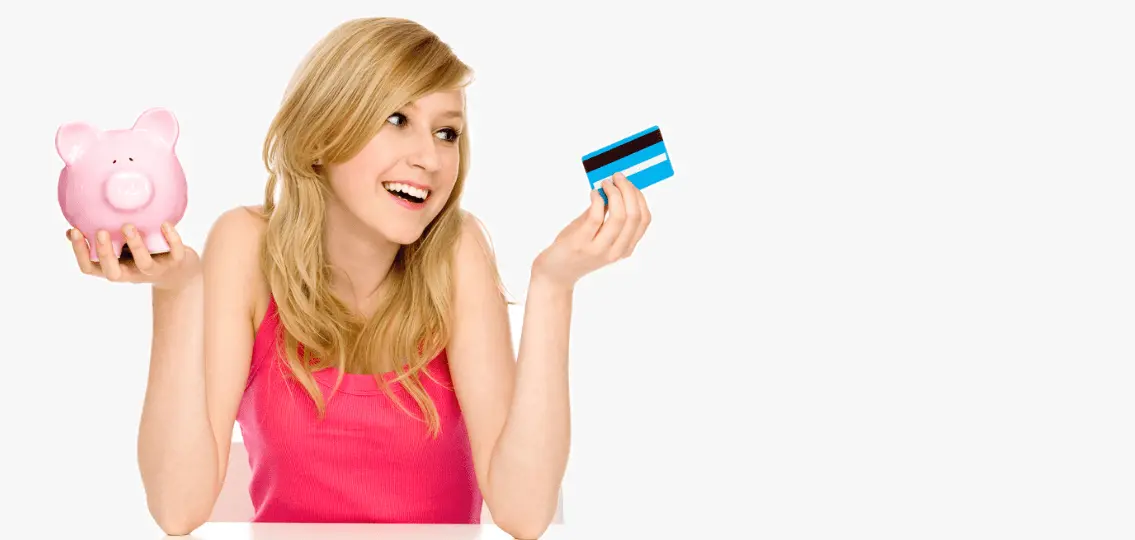 teen girl with piggy bank and credit card smiling and shrugging