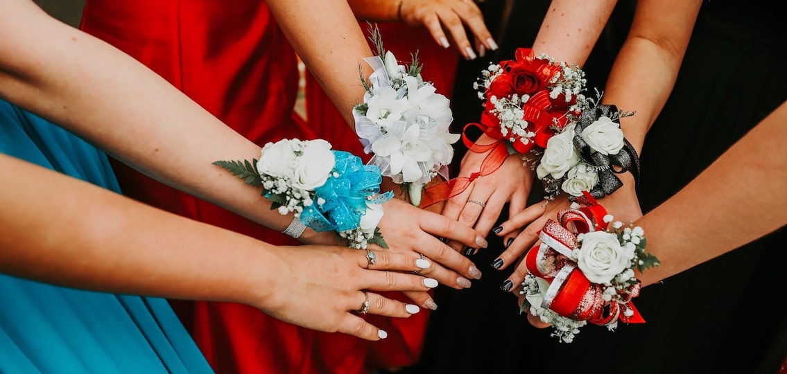 Girls showing off prom corsages close up
