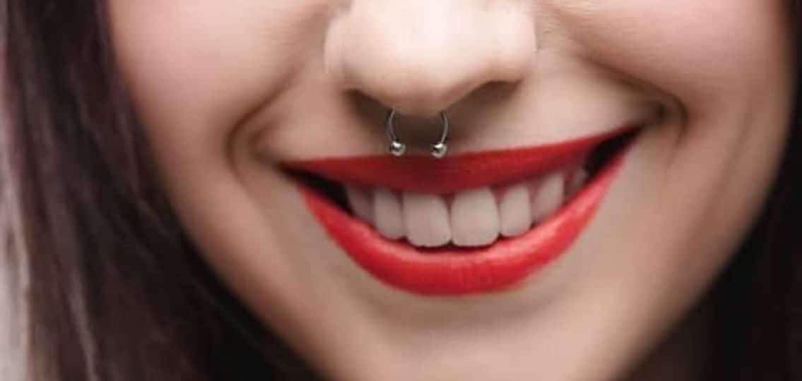 teenage girl smiling close up showing off her nose piercing