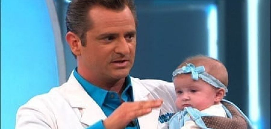Dr. Jim Sears holding a baby