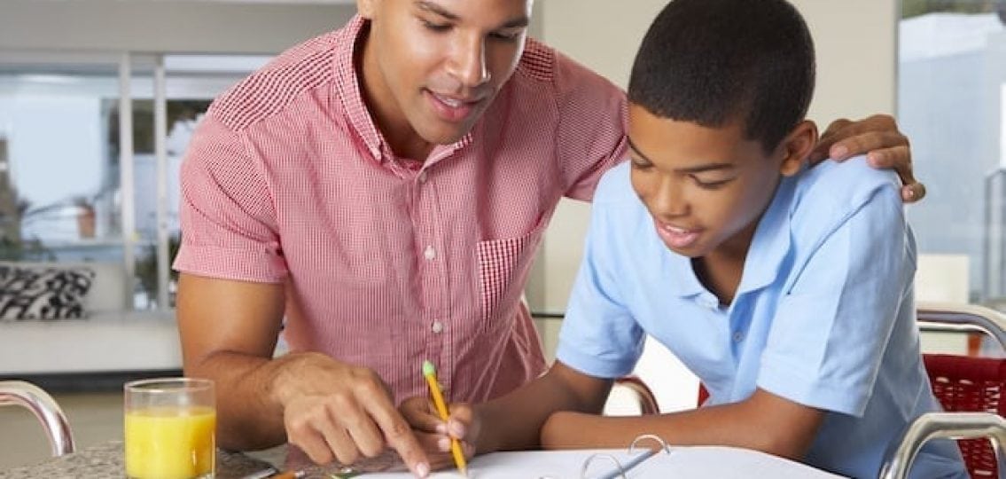 dad or older brother helping young middle schooler with studying