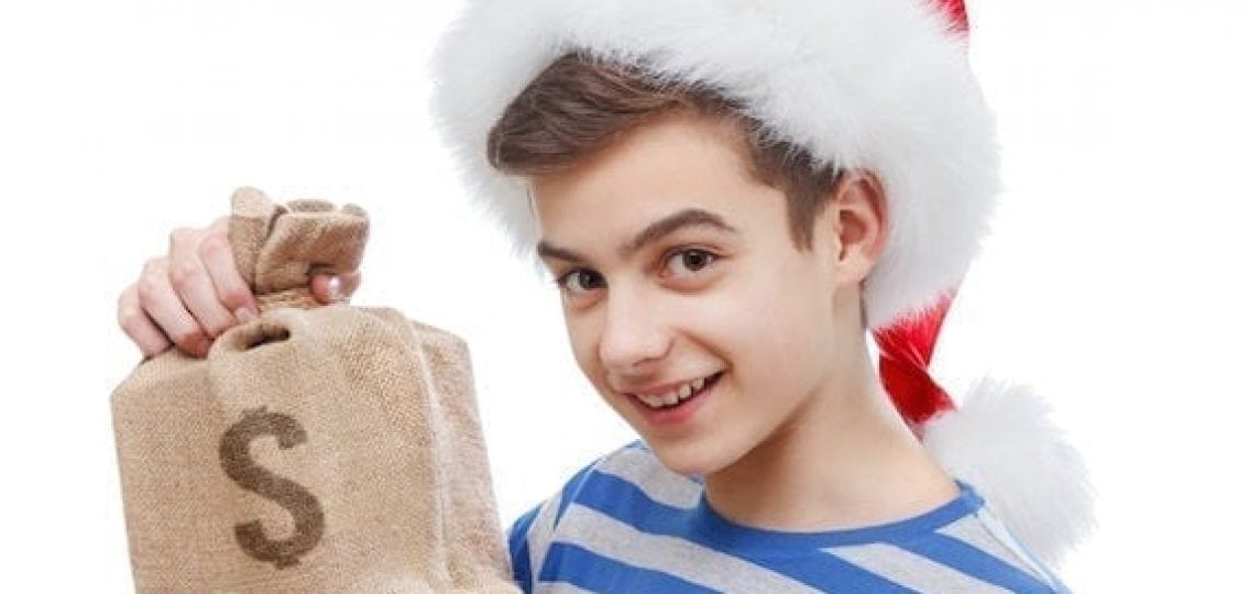 teen boy in a santa hat holding a bag of money