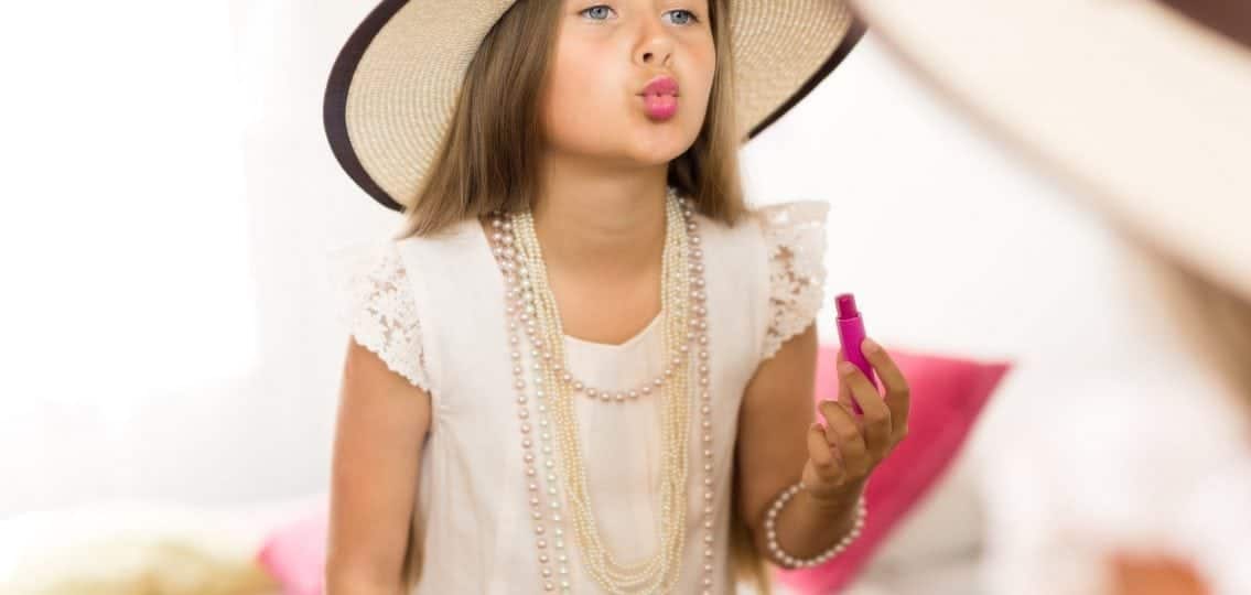 young girl playing dressup with her mom or sister's clothes and makeup