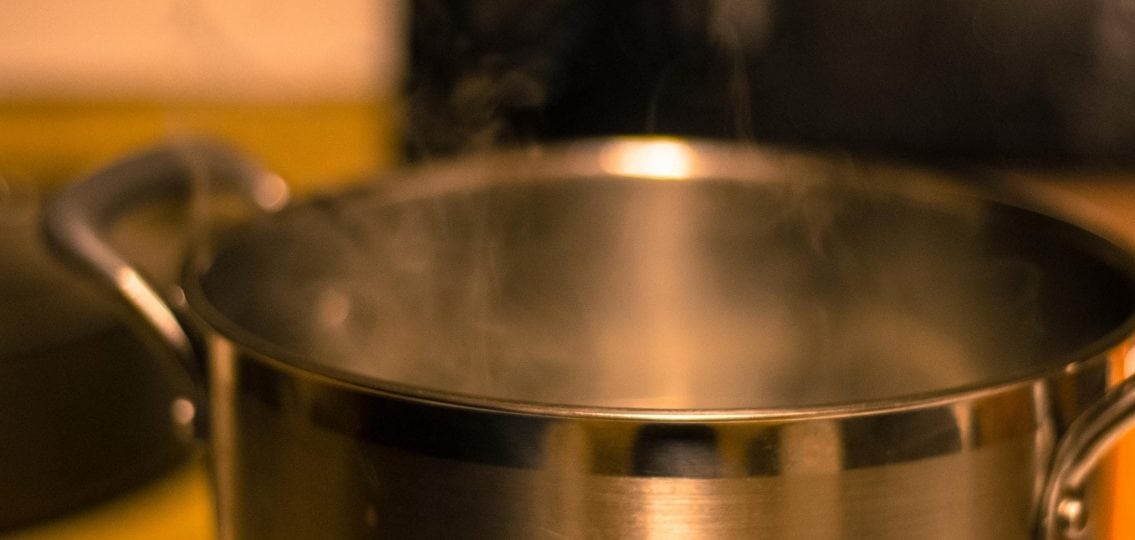 close up of a large pot with steam rising out