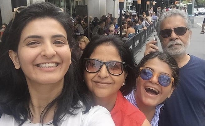 Indian parents and two daughters smiling selfie photo of author Saranya Misra