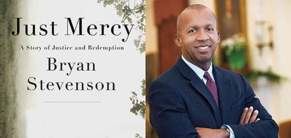 Author Bryan Stevenson in a suit next to a picture of his book: Just Mercy - A Story of Justice and Redemption