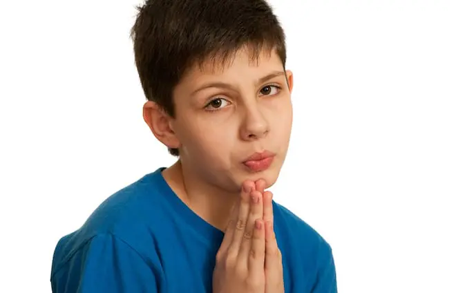 teen boy with hands praying