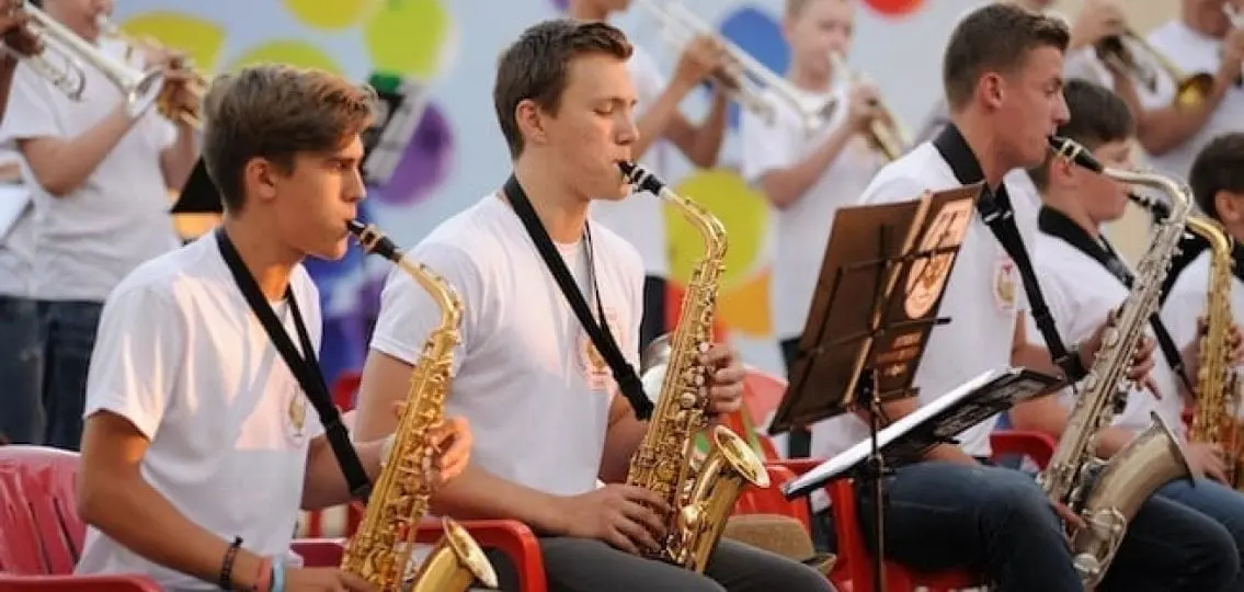 a high school band performing close up on the saxaphones