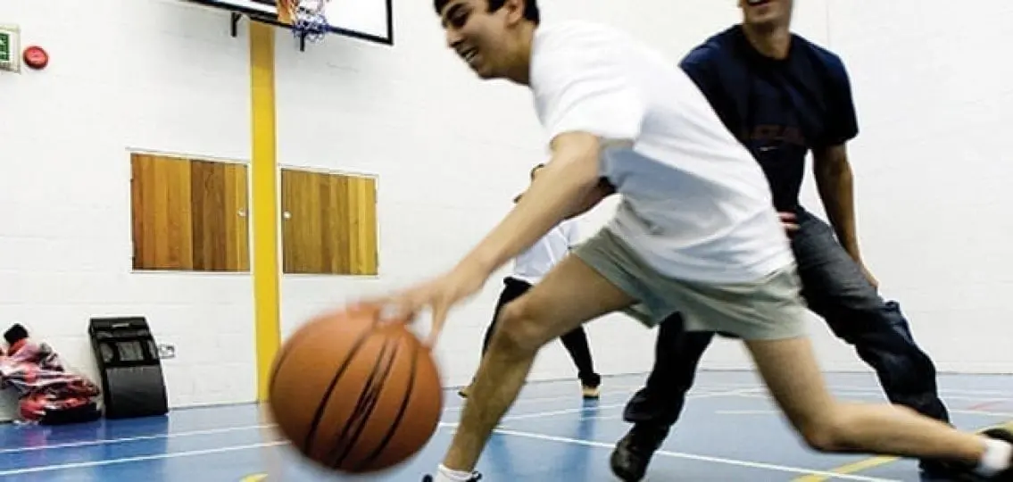 teen boys playing basketball