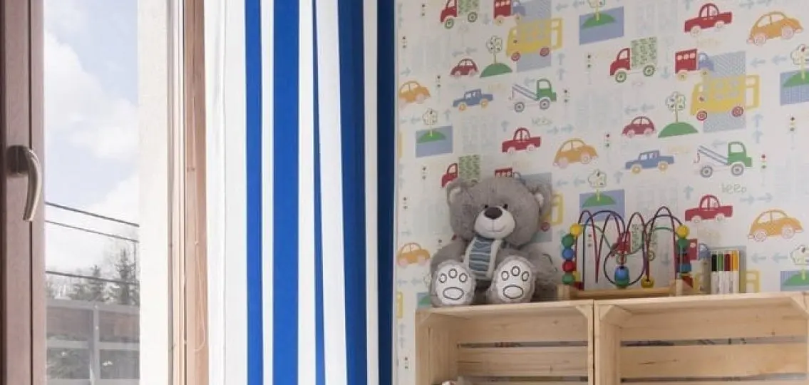 decorations for a young boys room with teddy bear small toys and car wallpaper