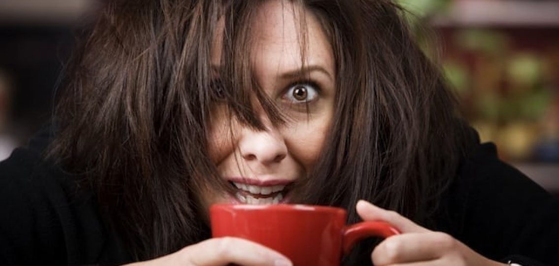 mom with messy hair drinking coffee