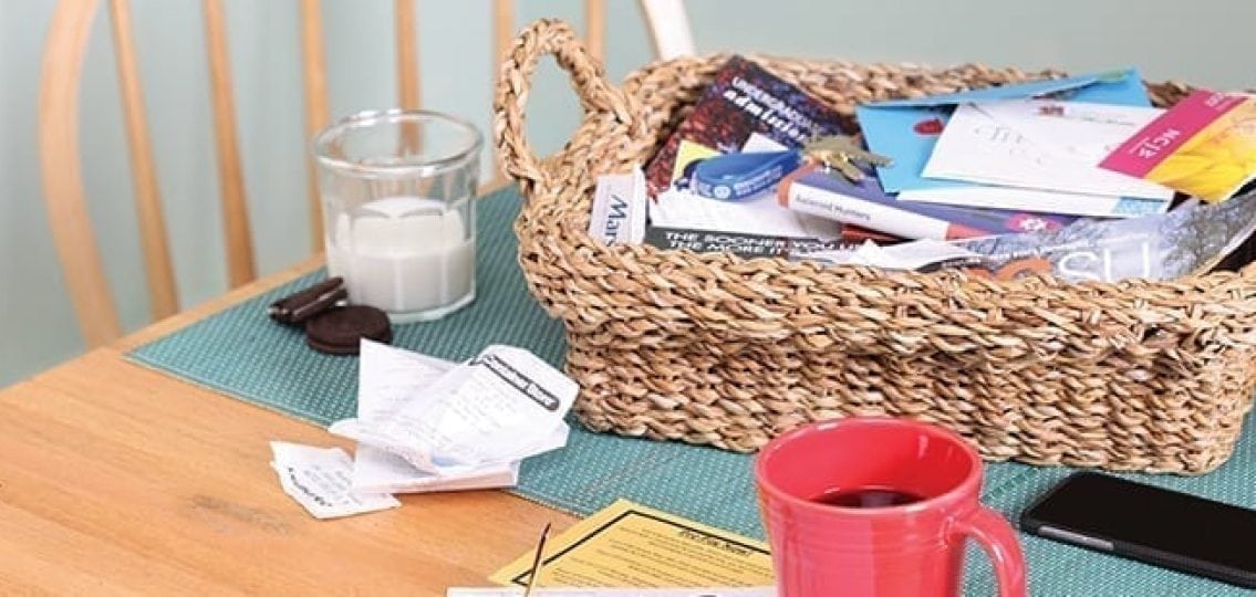 coffee cup around a pile of papers and receipts