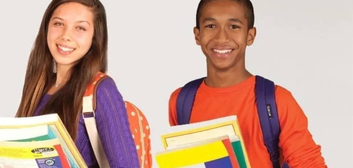 smiling teenagers carrying brightly colored books