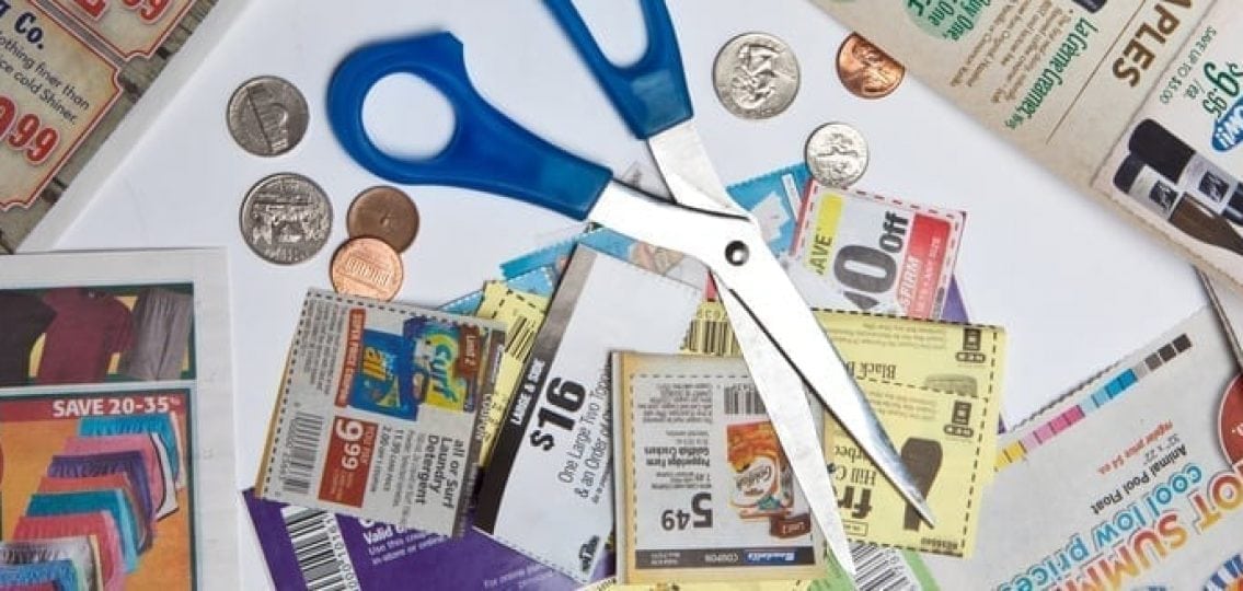 coupons with spare change and scissors
