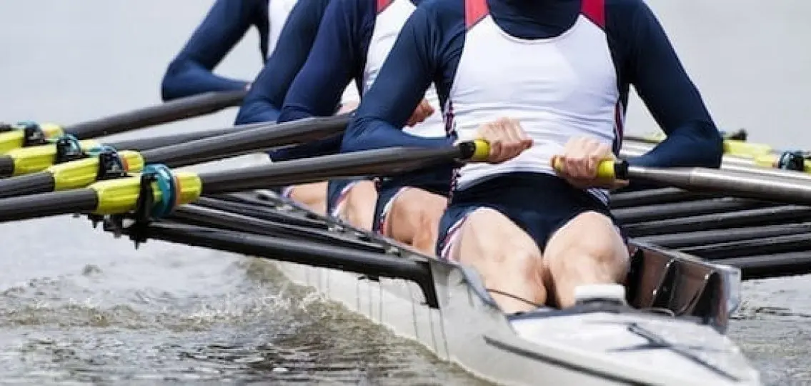 team of rowers rowing a boat cannot see over shoulders
