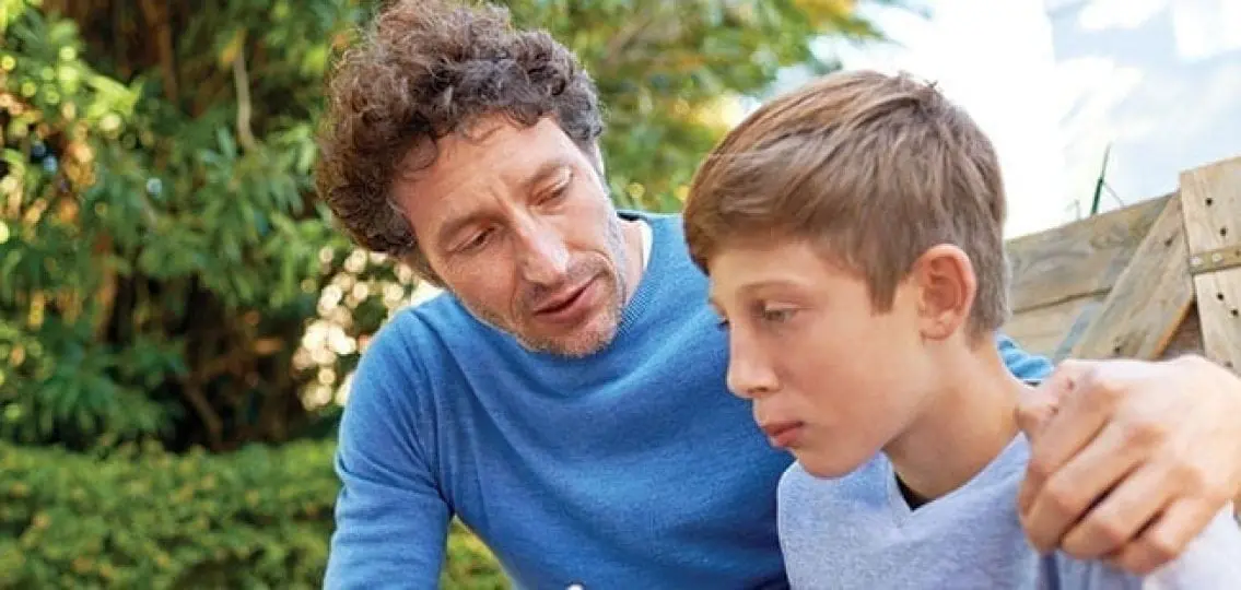dad having a serious talk with his middle school son