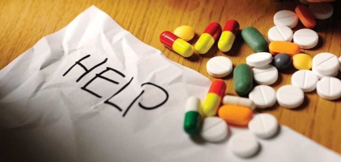 assorted prescription pulls of different colors on a paper with the word HELP written on it