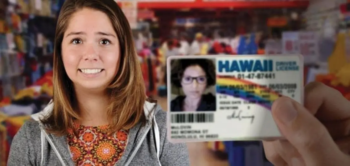 a fake id from hawaii next to a nervous teenage girl