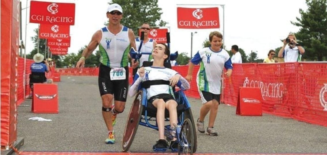 dad running a race while pushing his disabled son in a wheelchair