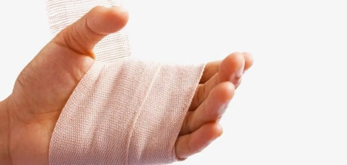 hand with a bandage wrapped around it on a white background