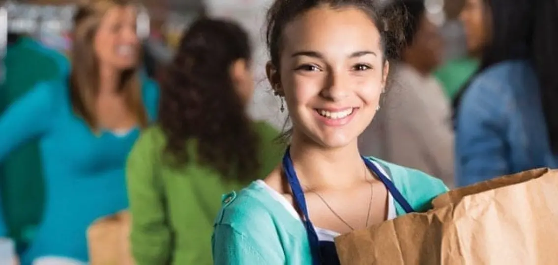 teenager bagging groceries in the grocery store
