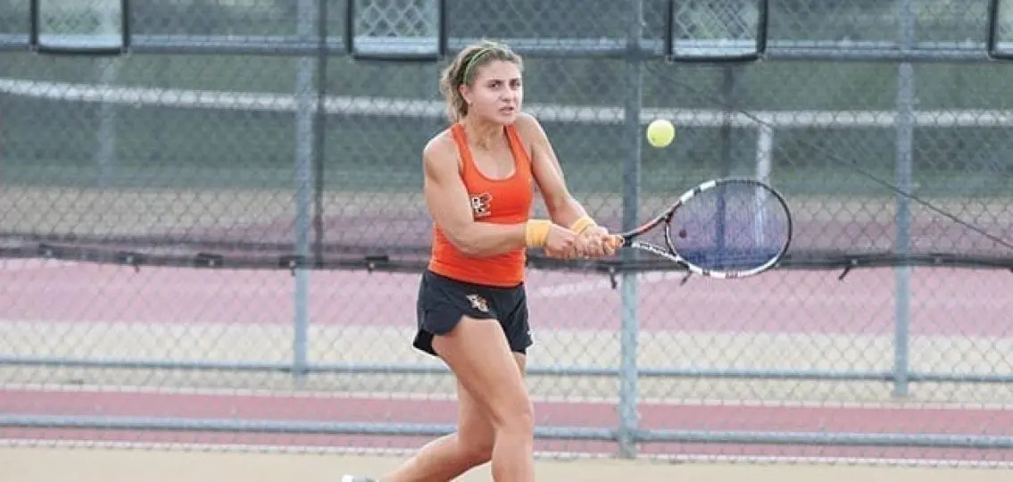college student playing tennis