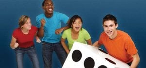 teenagers smiling and rolling a giant dice