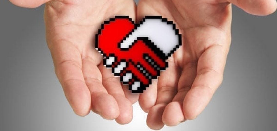 a hand holding an icon of two hands holding that look like a heart