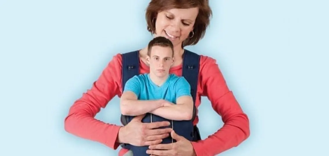 mom with teen boy in a baby carrier